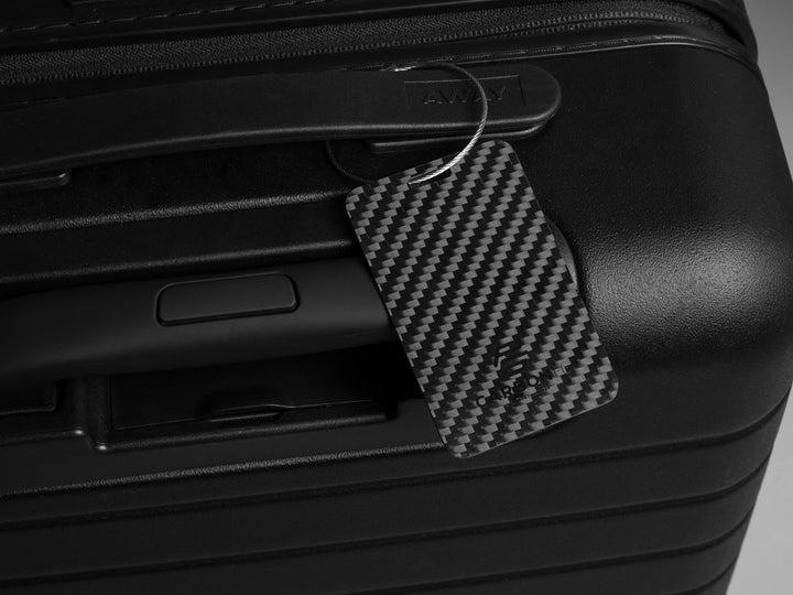 CarbonFG carbon fiber luggage tag on an Away bag