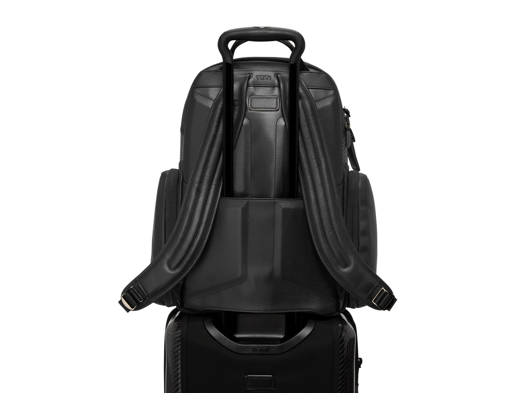 Close-up of the backpack's Add-a-Bag strap on luggage handle for travel convenience.
