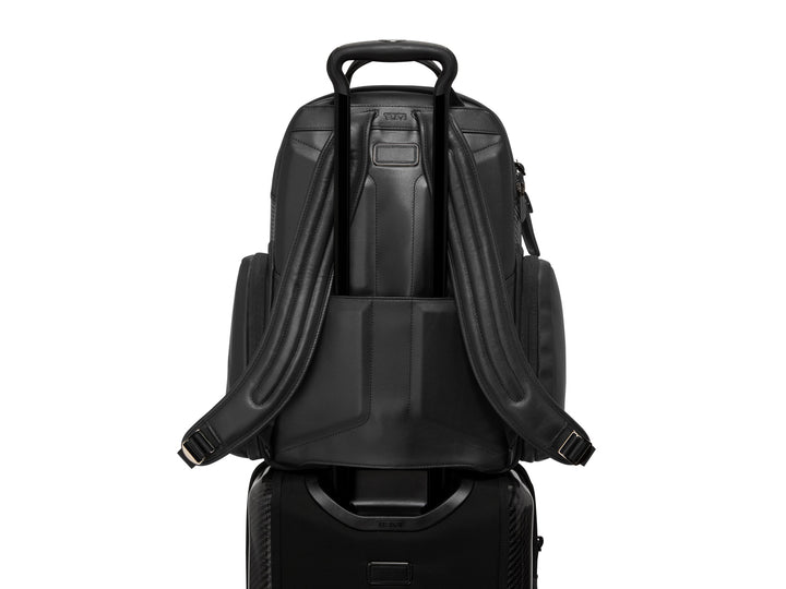 Close-up of the backpack's Add-a-Bag strap on luggage handle for travel convenience.