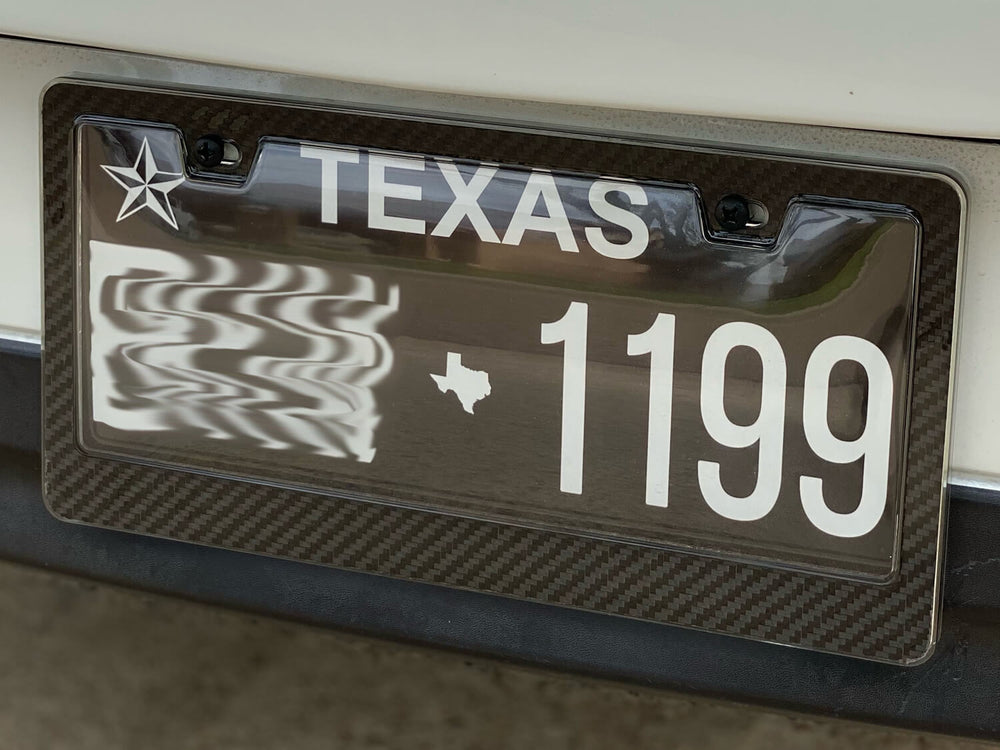 Installation example showing clear protective shield maintaining perfect plate visibility with premium carbon fiber frame