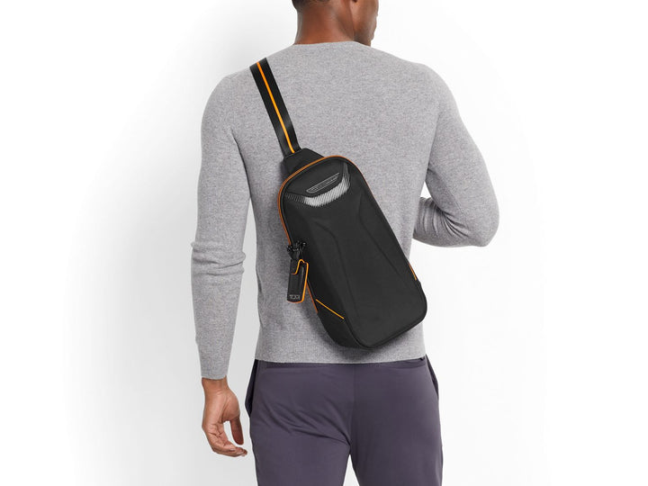 TUMI | McLaren Torque Sling on back#color_black-with-papaya