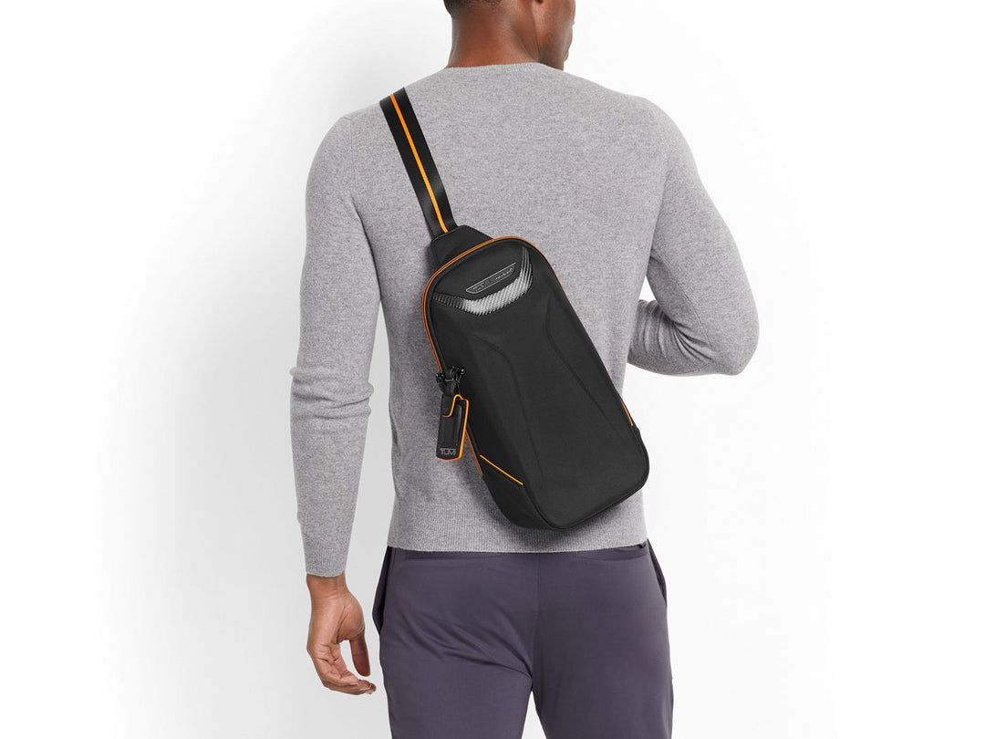 TUMI | McLaren Torque Sling on back#color_black-with-papaya